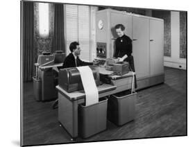 Man and a Women Working Together with a Pegasus Computer-null-Mounted Photographic Print