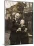 Man and Boy Holding a Dachshund-null-Mounted Photographic Print