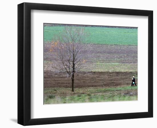 Man and Child Pass Through the Former Location of the Amish School in Nickel Mines, Pennsylvania-null-Framed Photographic Print