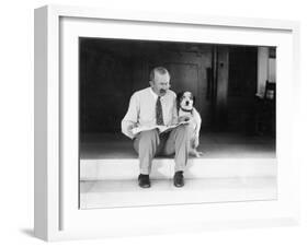 Man and Dog Sitting on the Steps Reading the Newspaper-null-Framed Photo