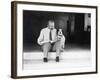 Man and Dog Sitting on the Steps Reading the Newspaper-null-Framed Photo