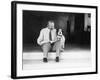 Man and Dog Sitting on the Steps Reading the Newspaper-null-Framed Photo