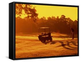 Man and Golf Cart Silhouetted at Sunset-Bill Bachmann-Framed Stretched Canvas