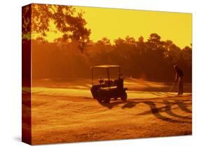 Man and Golf Cart Silhouetted at Sunset-Bill Bachmann-Stretched Canvas