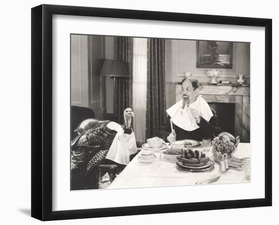 Man and His Pet Turkey Sitting Down to an Untraditonal Thanksgiving Dinner-null-Framed Photo