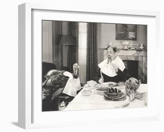 Man and His Pet Turkey Sitting Down to an Untraditonal Thanksgiving Dinner-null-Framed Photo