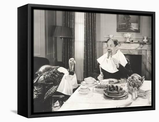 Man and His Pet Turkey Sitting Down to an Untraditonal Thanksgiving Dinner-null-Framed Stretched Canvas