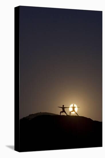 Man and Woman Practice Yoga in Front of a Full Moon in Grand Canyon National Park, Arizona-Louis Arevalo-Stretched Canvas