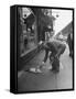 Man Bending over to Touch Cat Sitting on Sidewalk-Nina Leen-Framed Stretched Canvas