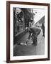 Man Bending over to Touch Cat Sitting on Sidewalk-Nina Leen-Framed Photographic Print