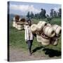 Man Carries Traditional Split-Bamboo Baskets to Sell at Kisoro Market, Southwest Uganda-Nigel Pavitt-Stretched Canvas