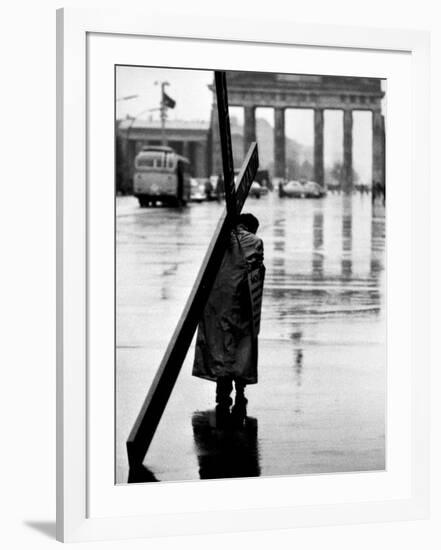 Man Carrying Cross, Berlin, October 1961-Toni Frissell-Framed Photo