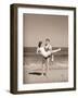 Man Carrying Woman on Beach-Philip Gendreau-Framed Photographic Print