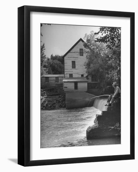 Man Fishing Beside a Waterfall and a 100 Year Old Mill-Bob Landry-Framed Photographic Print