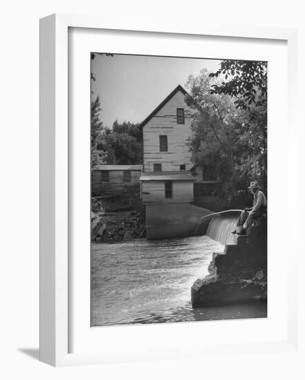Man Fishing Beside a Waterfall and a 100 Year Old Mill-Bob Landry-Framed Photographic Print