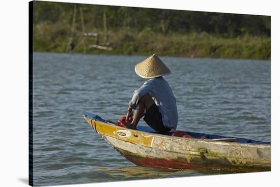 Man fishing from boat on Thu Bon River, Hoi An, Vietnam-David Wall-Stretched Canvas