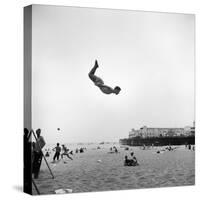 Man Flying Off a Trampoline at Santa Monica Beach-Loomis Dean-Stretched Canvas