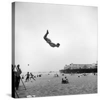 Man Flying Off a Trampoline at Santa Monica Beach-Loomis Dean-Stretched Canvas