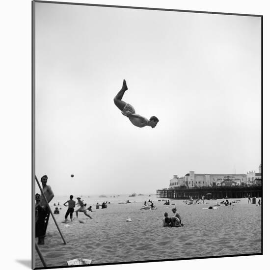 Man Flying Off a Trampoline at Santa Monica Beach-Loomis Dean-Mounted Photographic Print