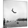 Man Flying Off a Trampoline at Santa Monica Beach-Loomis Dean-Mounted Photographic Print