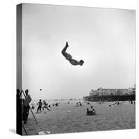 Man Flying Off a Trampoline at Santa Monica Beach-Loomis Dean-Stretched Canvas