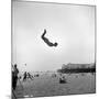 Man Flying Off a Trampoline at Santa Monica Beach-Loomis Dean-Mounted Photographic Print