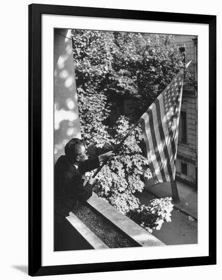 Man Hanging the American Flag Out of the Osteopath's Office Window During WWII-George Strock-Framed Photographic Print