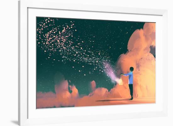 man holding a cage with floating star dust-Tithi Luadthong-Framed Art Print