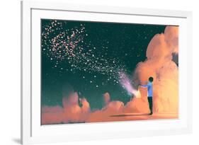 man holding a cage with floating star dust-Tithi Luadthong-Framed Art Print