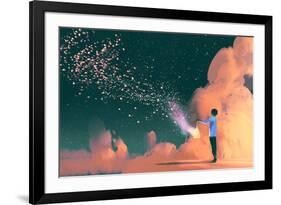 man holding a cage with floating star dust-Tithi Luadthong-Framed Art Print