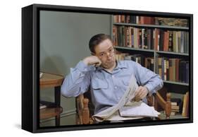 Man Holding Newspaper While Thinking-William P. Gottlieb-Framed Stretched Canvas