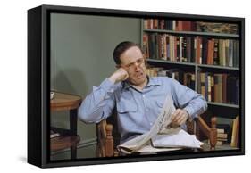 Man Holding Newspaper While Thinking-William P. Gottlieb-Framed Stretched Canvas