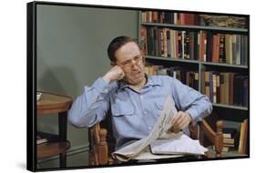 Man Holding Newspaper While Thinking-William P. Gottlieb-Framed Stretched Canvas