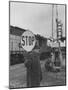 Man Holding Stop Sign by Hand While Automatic Gate Is Being Repaired-null-Mounted Photographic Print