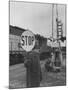 Man Holding Stop Sign by Hand While Automatic Gate Is Being Repaired-null-Mounted Photographic Print