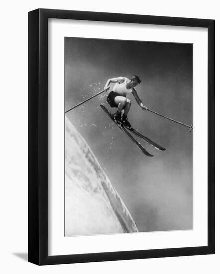 Man in a Vest in Mid-Air as He Skis Down a Steep Mountain-null-Framed Premium Photographic Print