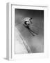 Man in a Vest in Mid-Air as He Skis Down a Steep Mountain-null-Framed Photographic Print