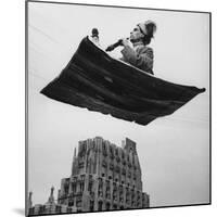 Man in Arabic Dress, Smoking a Water Cooled Pipe, is Comfortably Sitting on a Magic Carpet-Andreas Feininger-Mounted Photographic Print