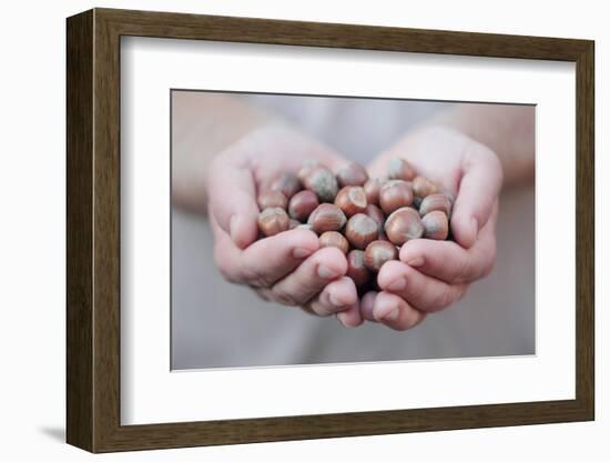 Man in Khaki T-Shirt Holds Hazelnuts in His Palms-Joe Petersburger-Framed Photographic Print