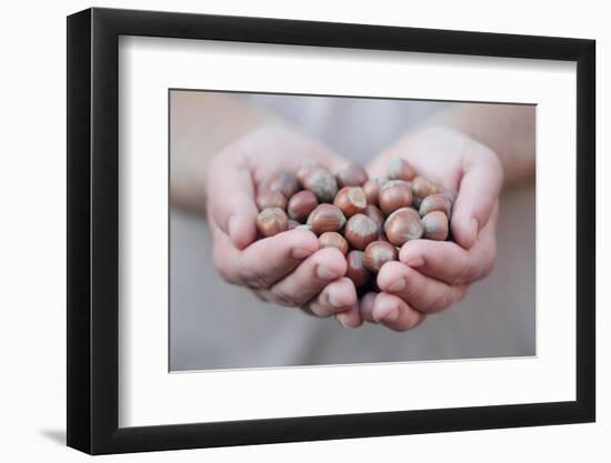 Man in Khaki T-Shirt Holds Hazelnuts in His Palms-Joe Petersburger-Framed Photographic Print