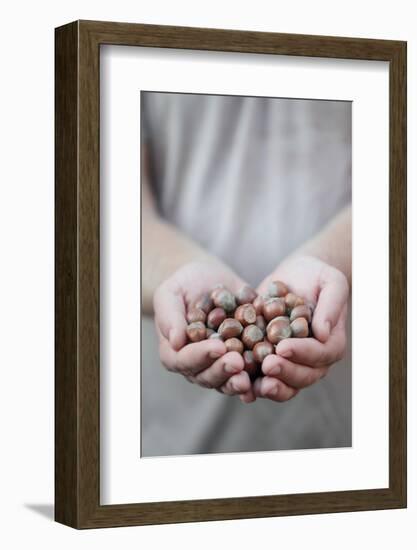 Man in Khaki T-Shirt Holds Hazelnuts in His Palms-Joe Petersburger-Framed Photographic Print