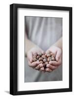 Man in Khaki T-Shirt Holds Hazelnuts in His Palms-Joe Petersburger-Framed Photographic Print