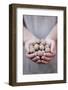 Man in Khaki T-Shirt Holds Walnuts in His Palms-Joe Petersburger-Framed Photographic Print