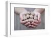 Man in Khaki T-Shirt Holds Walnuts in His Palms-Joe Petersburger-Framed Photographic Print