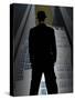 Man in Suit and Bowler Hat Standing in Front of Skyscraper-null-Stretched Canvas