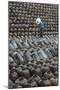 Man in the middle of big pile of wine jars stacked up at a local rice winery, Wuxi, China-Keren Su-Mounted Photographic Print