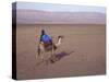 Man in Traditional Dress Riding Camel, Morocco-Merrill Images-Stretched Canvas