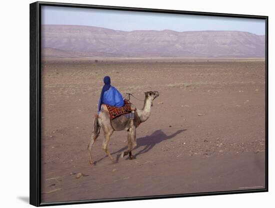 Man in Traditional Dress Riding Camel, Morocco-Merrill Images-Framed Photographic Print