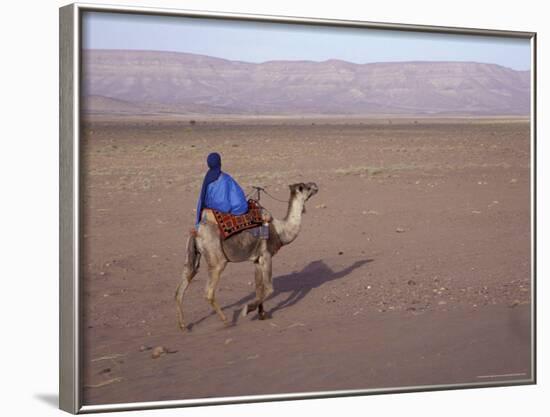 Man in Traditional Dress Riding Camel, Morocco-Merrill Images-Framed Photographic Print