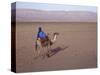 Man in Traditional Dress Riding Camel, Morocco-Merrill Images-Stretched Canvas